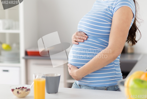 Image of close up of pregnant woman touching her belly