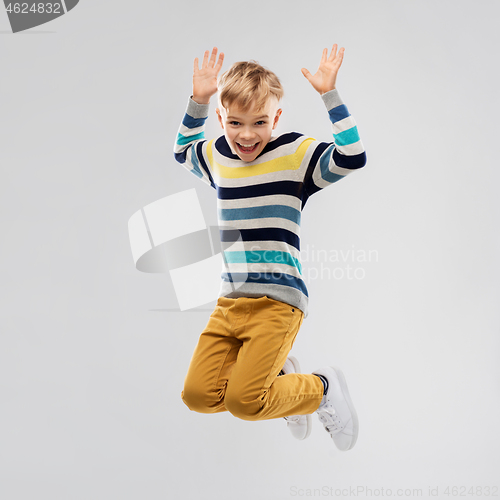 Image of happy little boy jumping and having fun