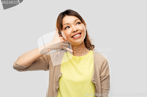 Image of african asian making phone call gesture