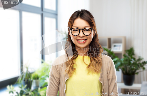 Image of happy asian woman in glasses at home