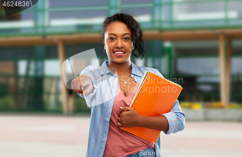 Image of african american student woman with notebooks