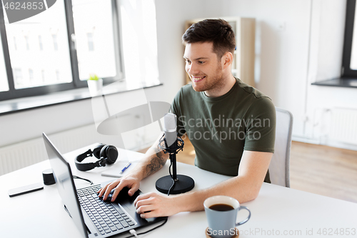 Image of blogger with laptop and microphone audio blogging