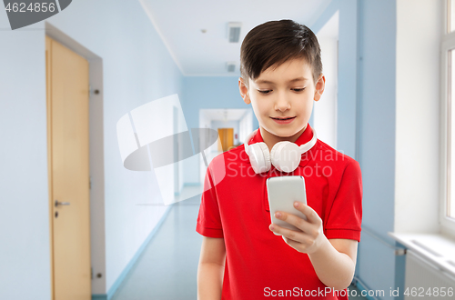 Image of boy in red t-shirt with headphones and smartphone