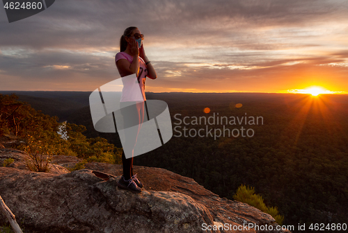 Image of Athletic woman wearing a medical protection mask outdoors in nat