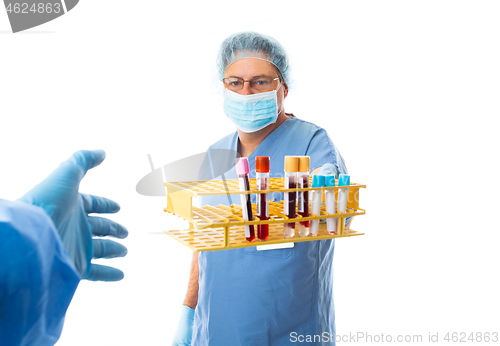 Image of Hospital staff hands over blood test  i to another laboratory wo