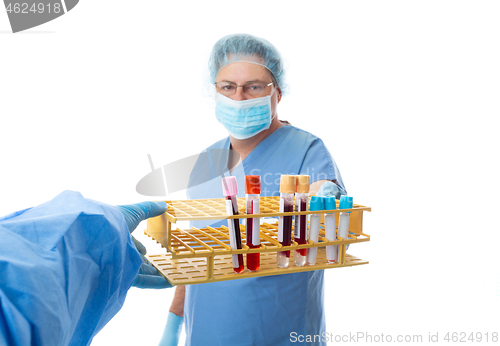 Image of Pathologist hands blood tests to a laboratory worker