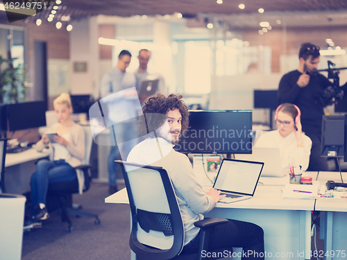 Image of businessman working using a laptop in startup office