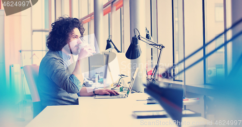 Image of businessman working using a laptop in startup office