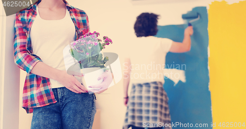 Image of happy young couple doing home renovations