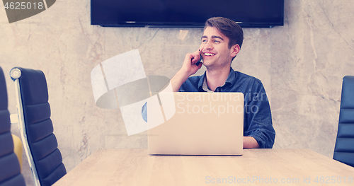 Image of businessman working using a laptop in startup office