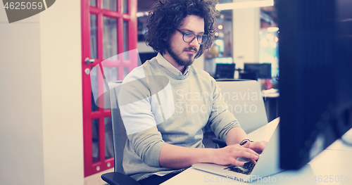 Image of businessman working using a laptop in startup office