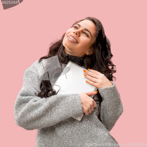 Image of Businesswoman hugging laptop. Love to computer concept.