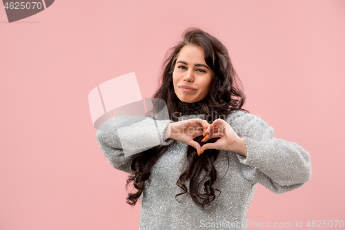 Image of Portrait of attractive cute girl with bright makeup with kiss and love sign isolated over pink background