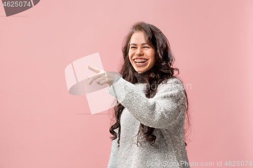 Image of The happy business woman point you and want you, half length closeup portrait on pink background.