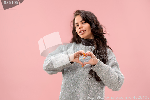 Image of Portrait of attractive cute girl with bright makeup with kiss and love sign isolated over pink background