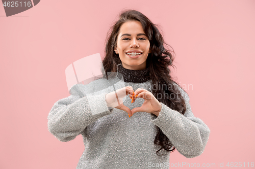Image of Portrait of attractive cute girl with bright makeup with kiss and love sign isolated over pink background