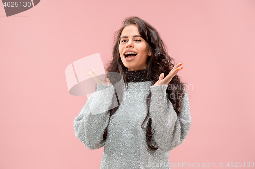 Image of Beautiful woman looking suprised isolated on pink