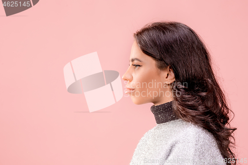 Image of The happy business woman standing and smiling against pastel background.