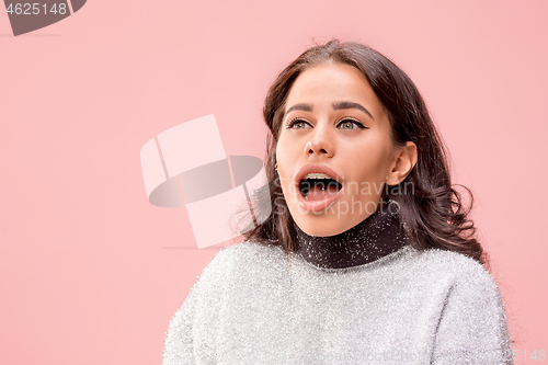 Image of Beautiful woman looking suprised isolated on pink