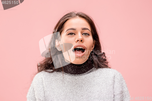 Image of Beautiful woman looking suprised isolated on pink