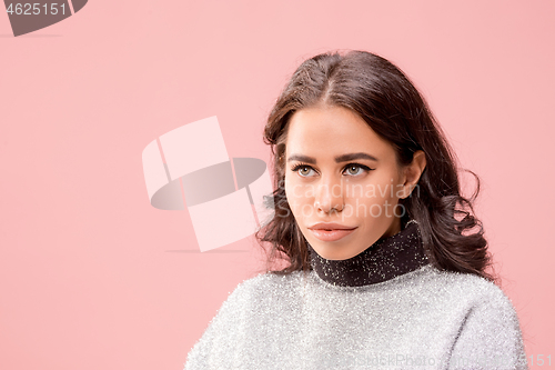 Image of Serious business woman standing, looking at camera isolated on trendy pink studio background.