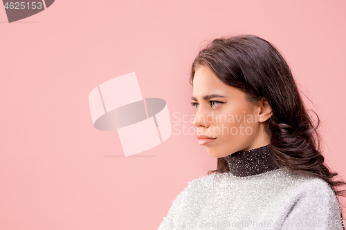 Image of The happy business woman standing and smiling against pastel background.