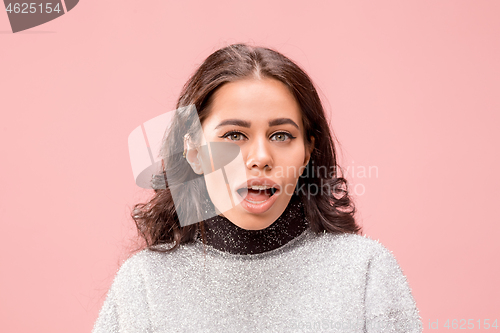 Image of Beautiful woman looking suprised isolated on pink