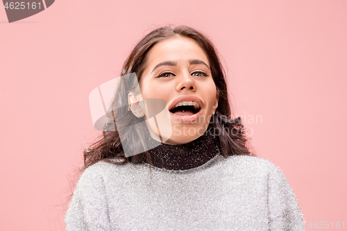 Image of Beautiful woman looking suprised isolated on pink