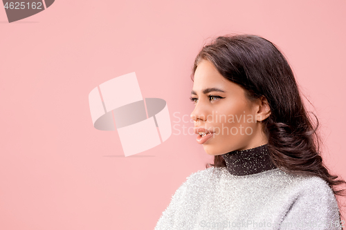 Image of The happy business woman standing and smiling against pastel background.