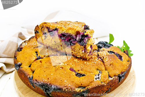 Image of Pie with black grapes on wooden board