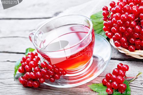 Image of Tea from viburnum in cup on wooden board