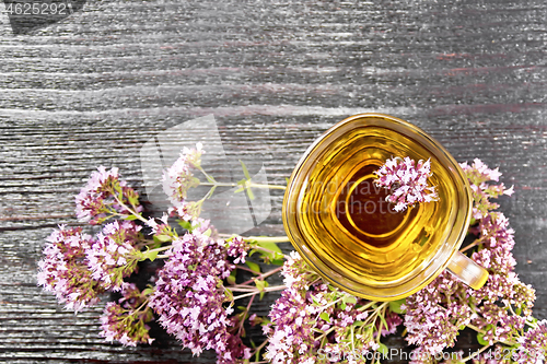 Image of Tea of oregano in glass cup on board top