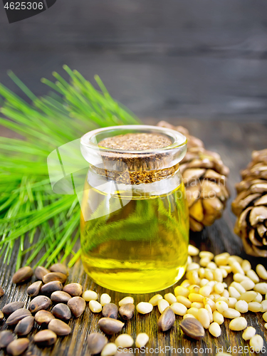 Image of Oil cedar in glass jar on wooden board