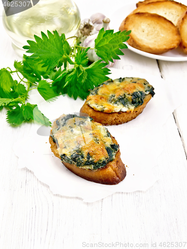 Image of Sandwich of nettle and cheese on white board