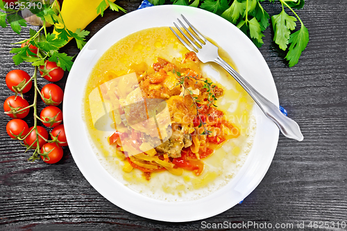 Image of Chicken with pepper in white plate on dark board top