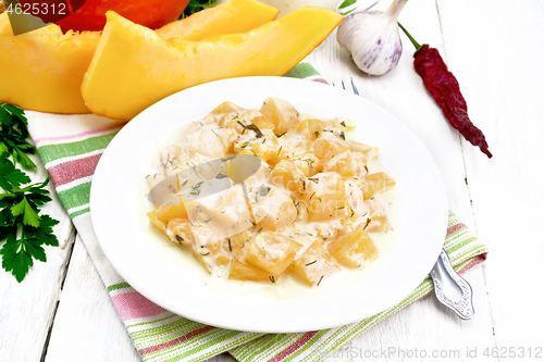 Image of Pumpkin with sour cream sauce in plate on white board