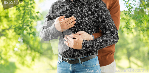 Image of close up of hugging male gay couple