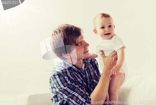 Image of happy young father with little baby at home