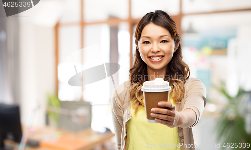 Image of happy asian woman drinking coffee at office