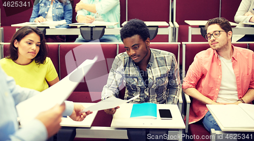 Image of teacher giving tests to students at lecture