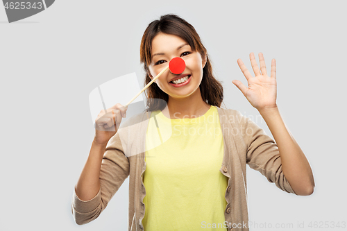 Image of happy asian woman with red clown nose