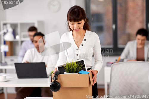 Image of female employee with personal stuff at office