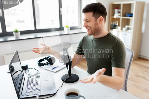 Image of blogger with laptop and microphone audio blogging