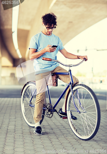 Image of man with smartphone and earphones on bicycle