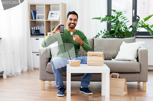 Image of indian man using smartphone for food delivery