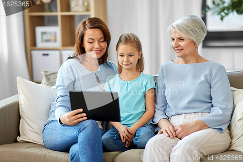 Image of mother, daughter and grandmother with tablet pc