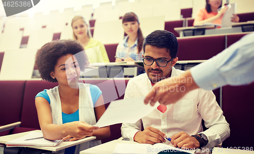 Image of teacher giving tests to students at lecture