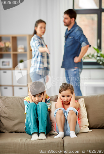 Image of sad children and parents quarreling at home