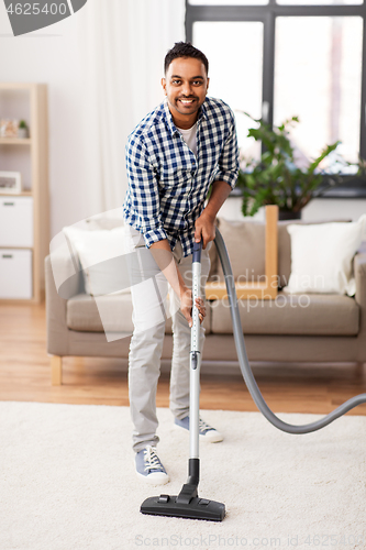 Image of indian man with vacuum cleaner at home