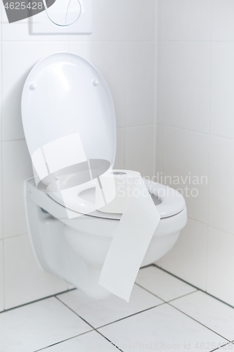 Image of White toilet with toilet paper